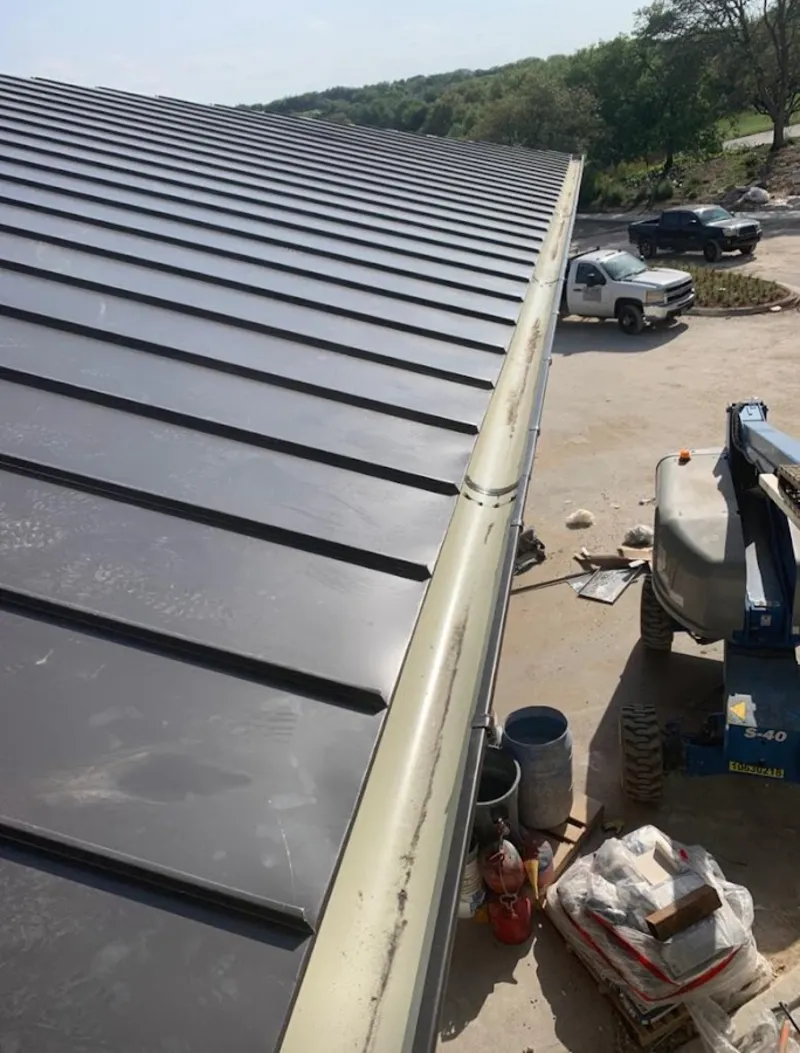Standing seam panel and gutter detail on a metal roofing jobsite in Southside